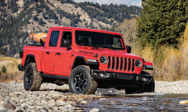 2022 Jeep Gladiator driving in a stream