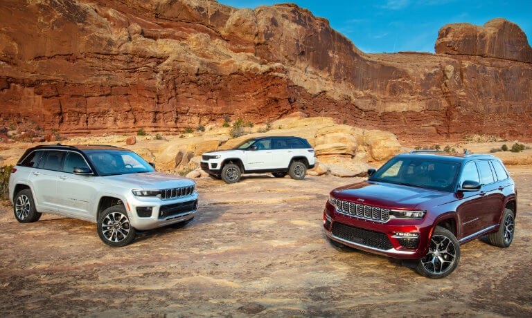 Three 2022 Jeep Grand Cherokees parked in the desert