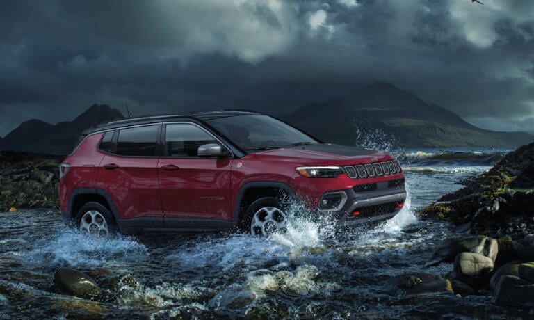 2023 Jeep Compass driving in a stream