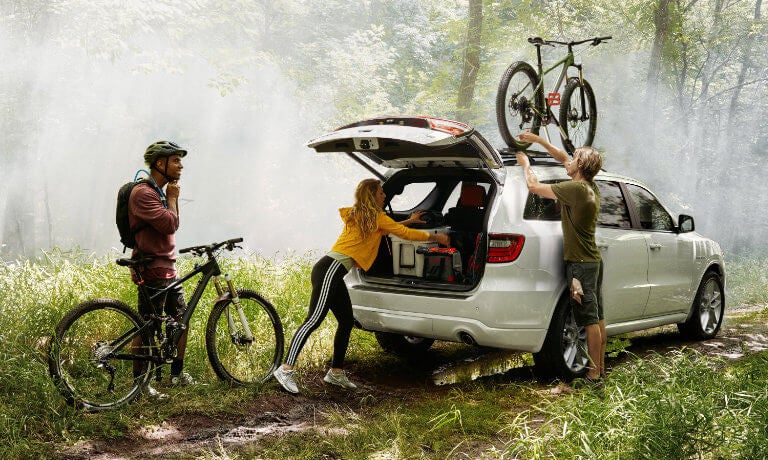 2022 Dodge Durango with bikers in forest