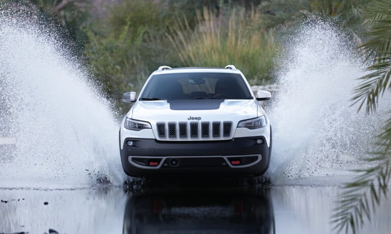 2023 Jeep Cherokee splashing in a stream