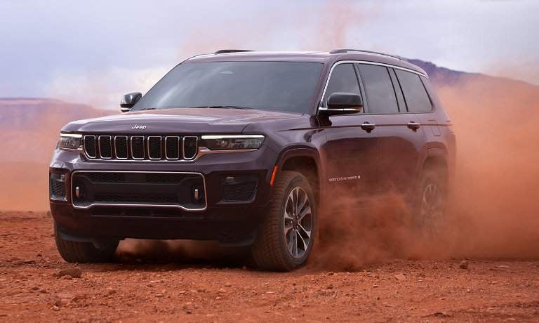 2023 Jeep Grand Cherokee L kicking up red dust