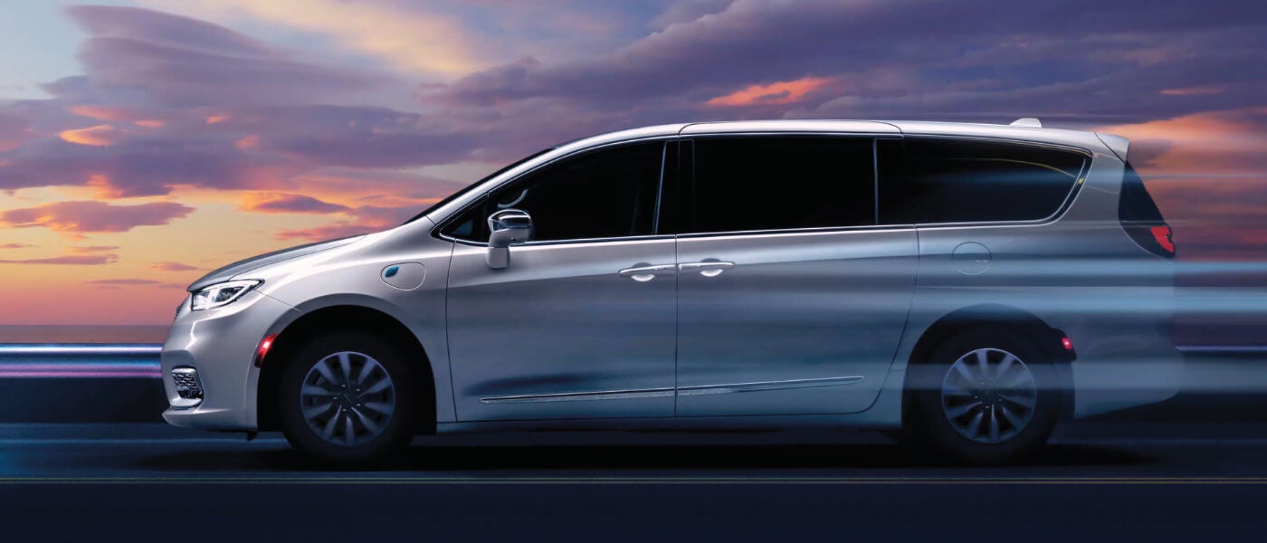 2024 Chrysler Pacifica Plug-In Hybrid driving fast at sunset