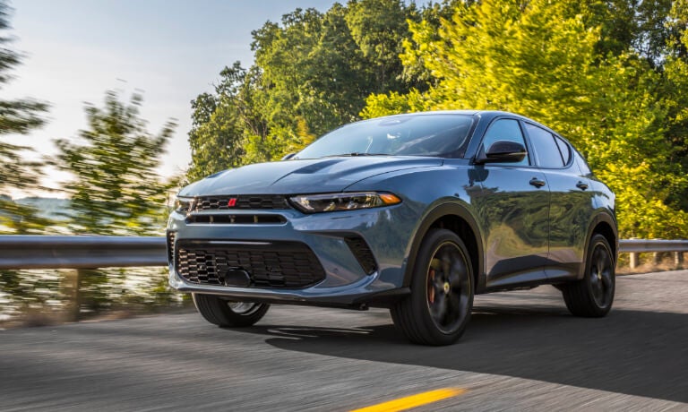 2024 Dodge Hornet driving on wooded highway