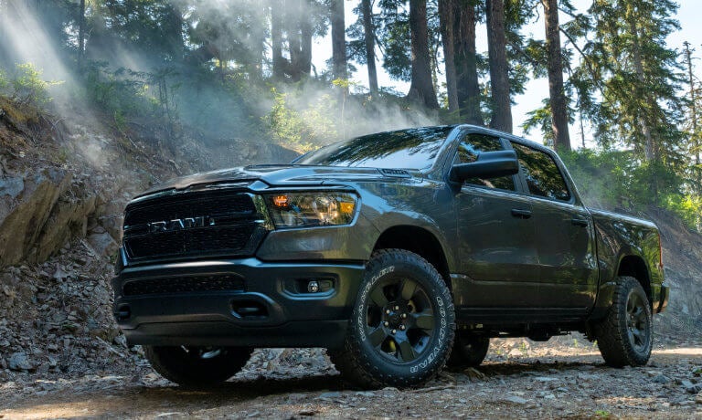 2024 Ram 1500 parked on forest sunbeams