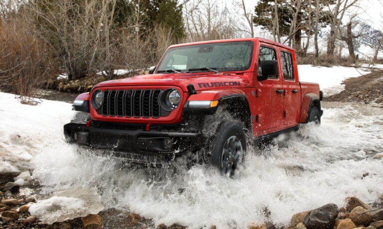 2025 Jeep Gladiator driving in a stream