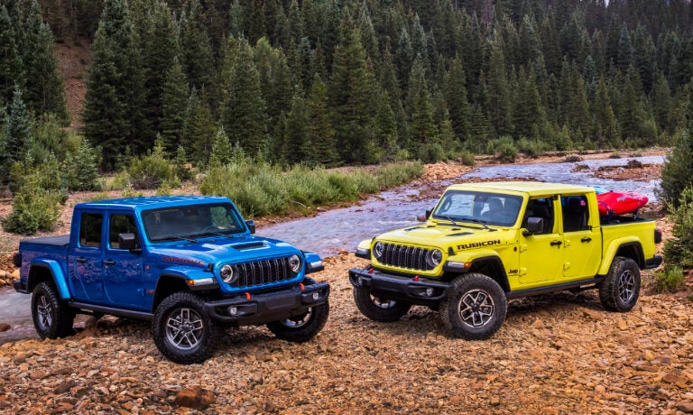Two 2025 Jeep Gladiators parked by a stream