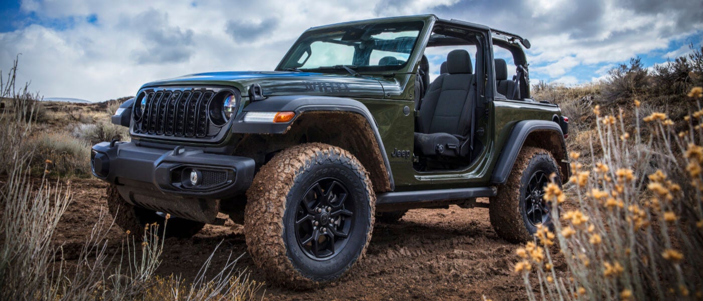 2025 Jeep Wrangler in a field with the doors off